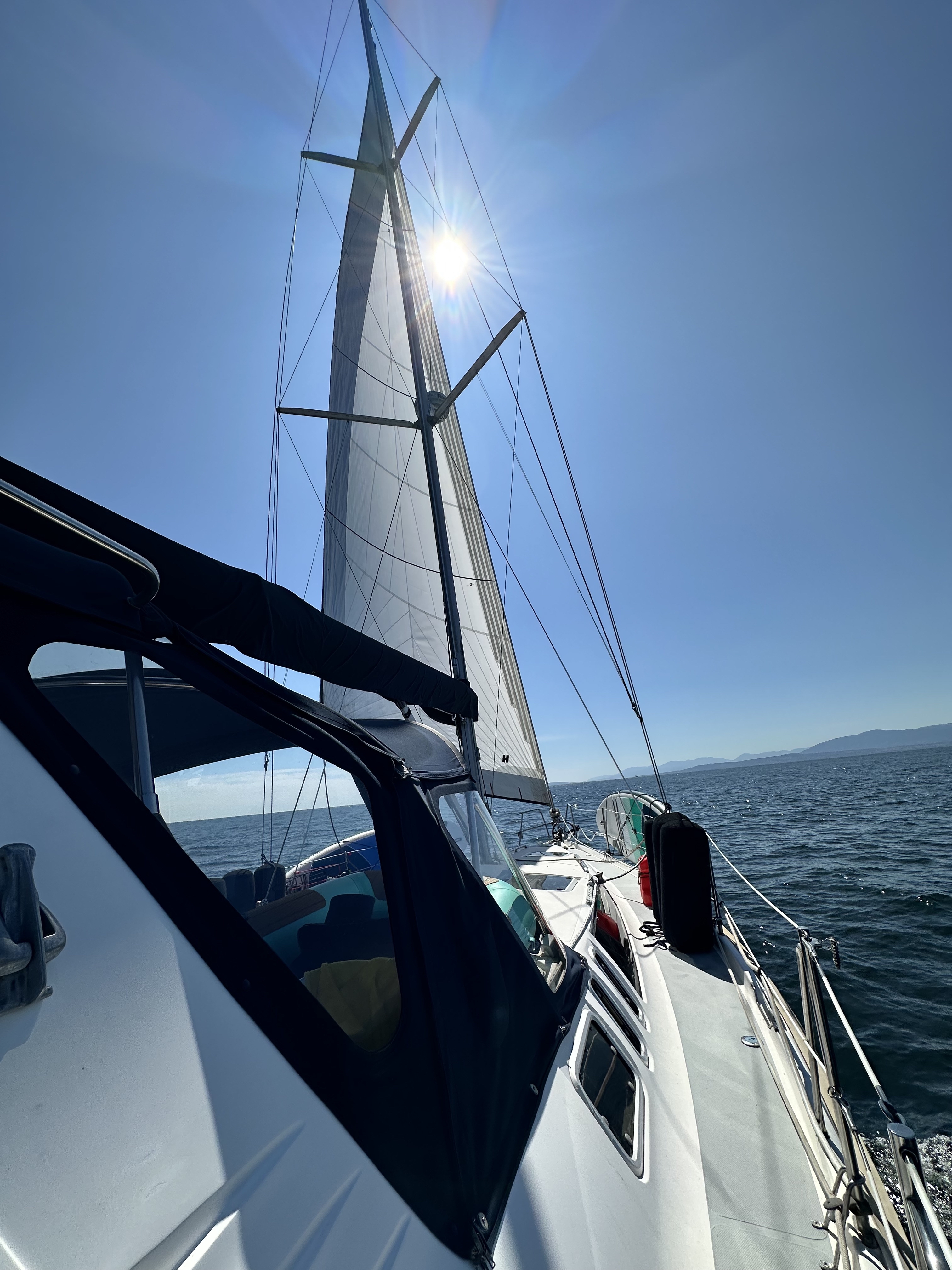 Oceanus sailing under a clear blue sky