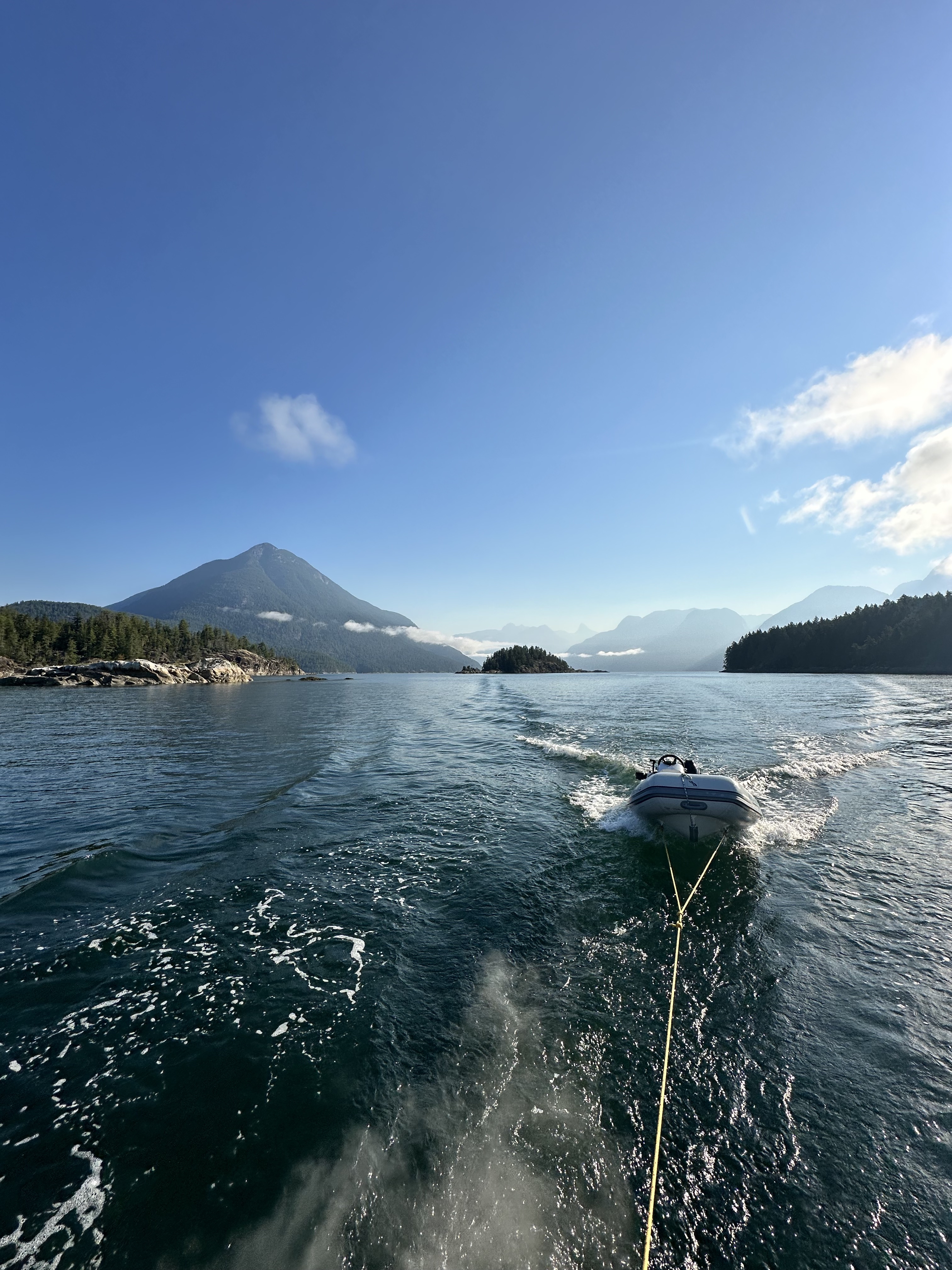 Dinghy being towed through Desolation Sound