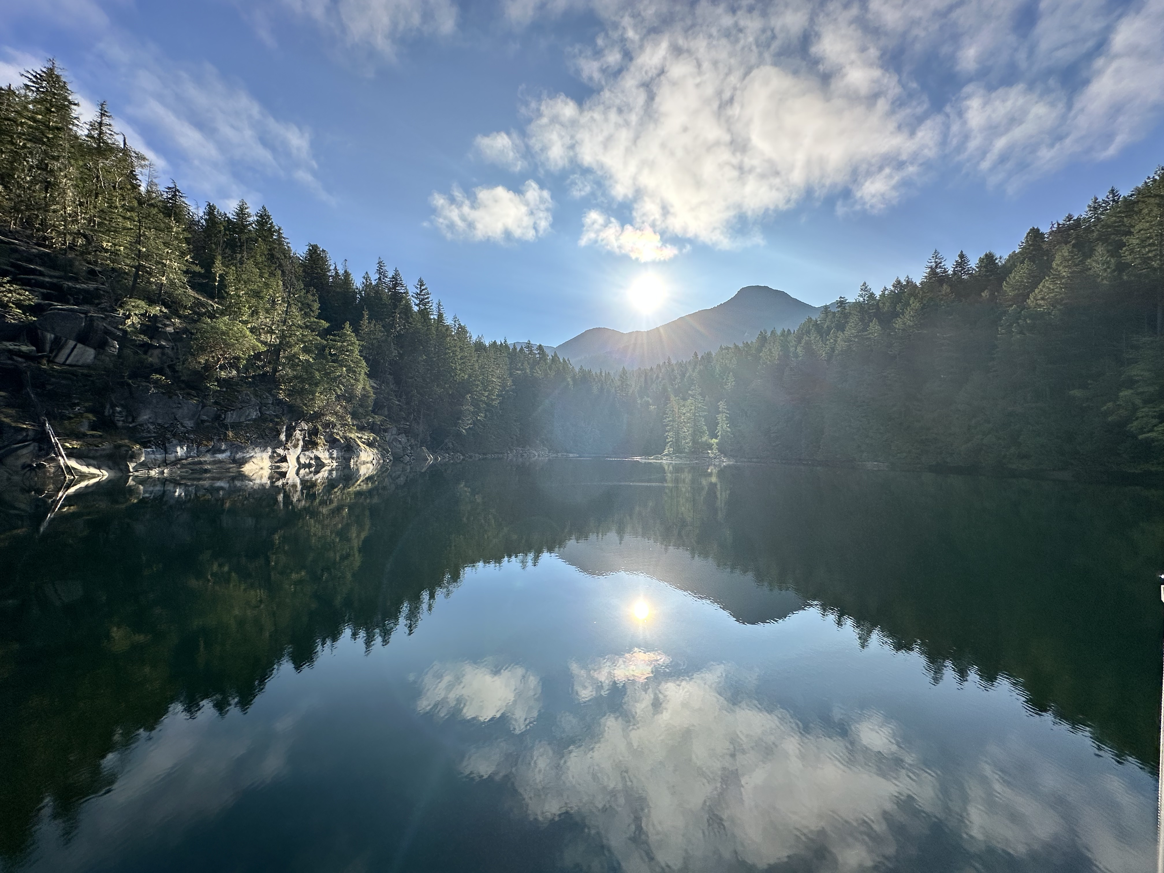 Mountain and cloud reflections in Melanie Cove