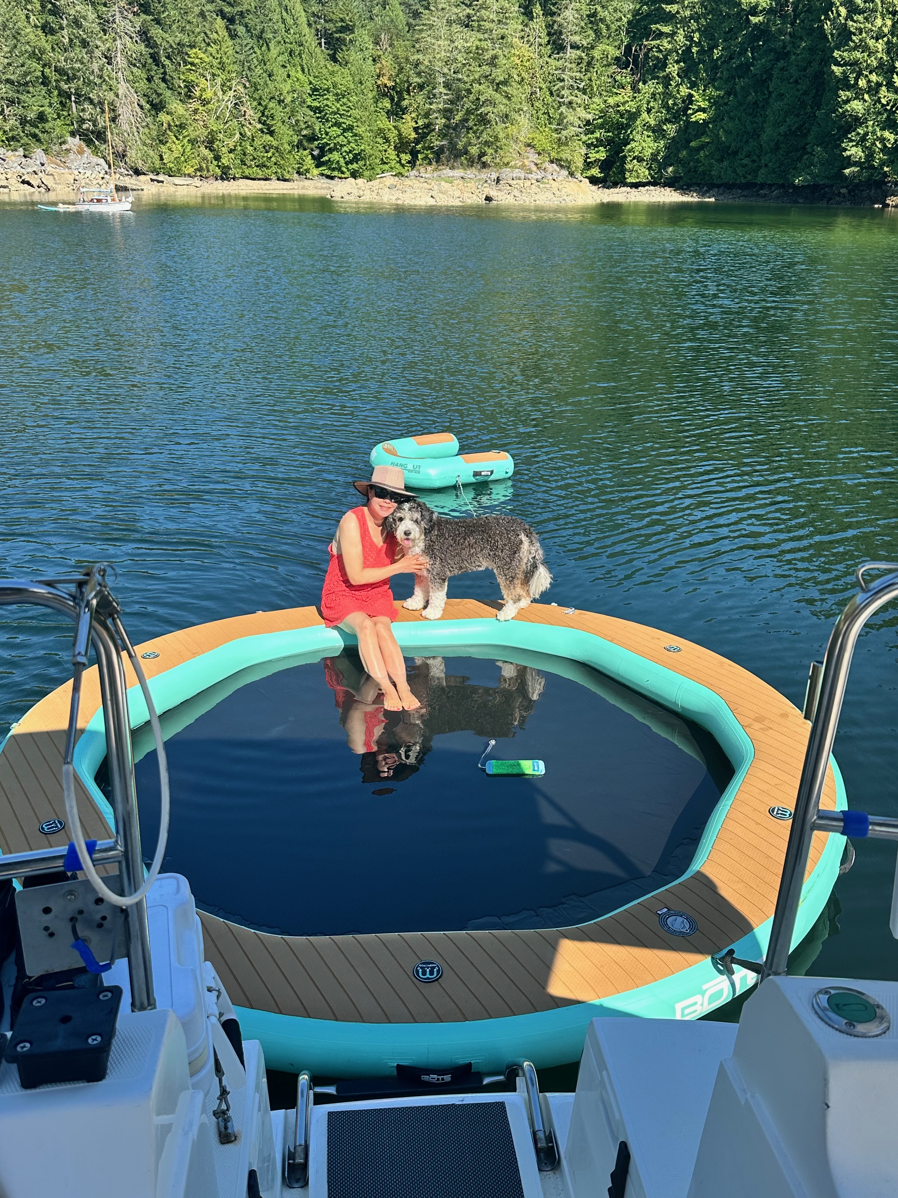 Yinglan and Shadow relaxing on the floating swim platform in Melanie Cove